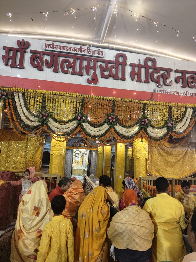 Maa Baglamukhi Mandir Entrance — Devotees in Yellow, Nalkheda